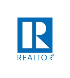 Blue logo of the national association of realtors with a white background