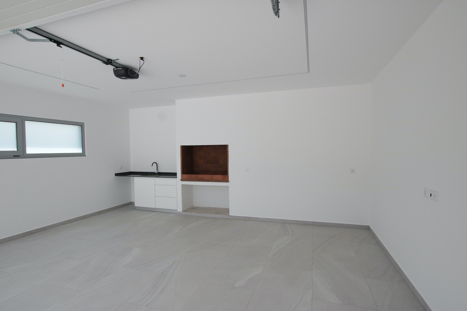 Garage with sink and barbecue area