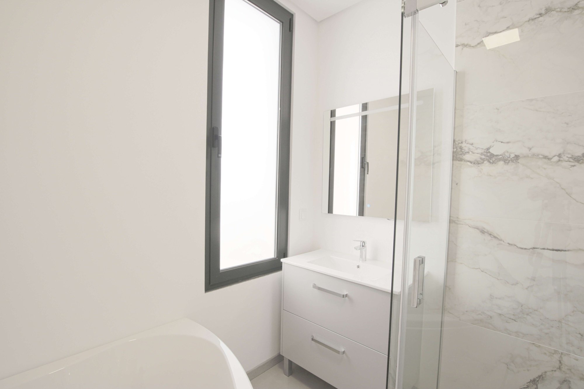 Bathroom with bathtub, shower and hand basin