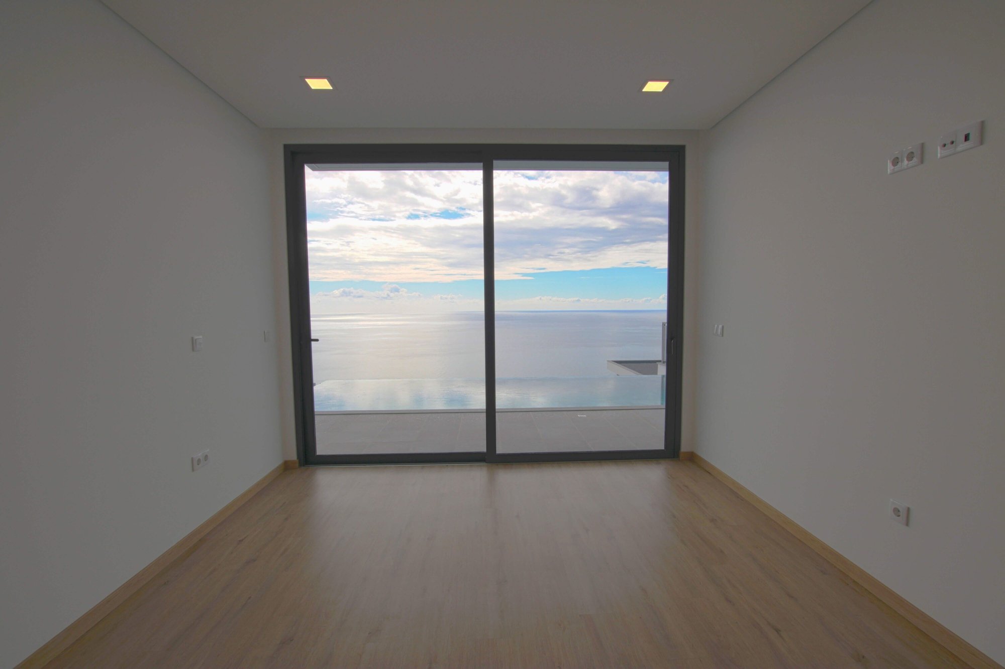 Empty room with swimming pool and ocean view