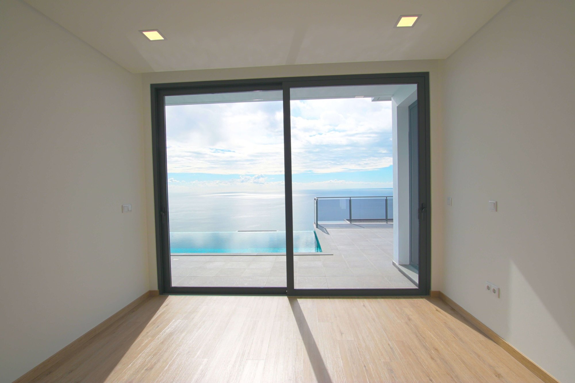 Empty room with swimming pool and ocean view