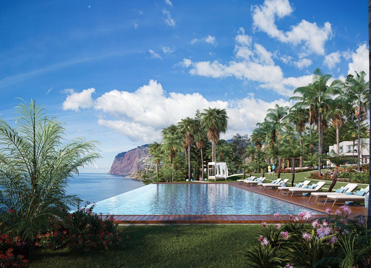 swimming pool area with a garden and a sea view