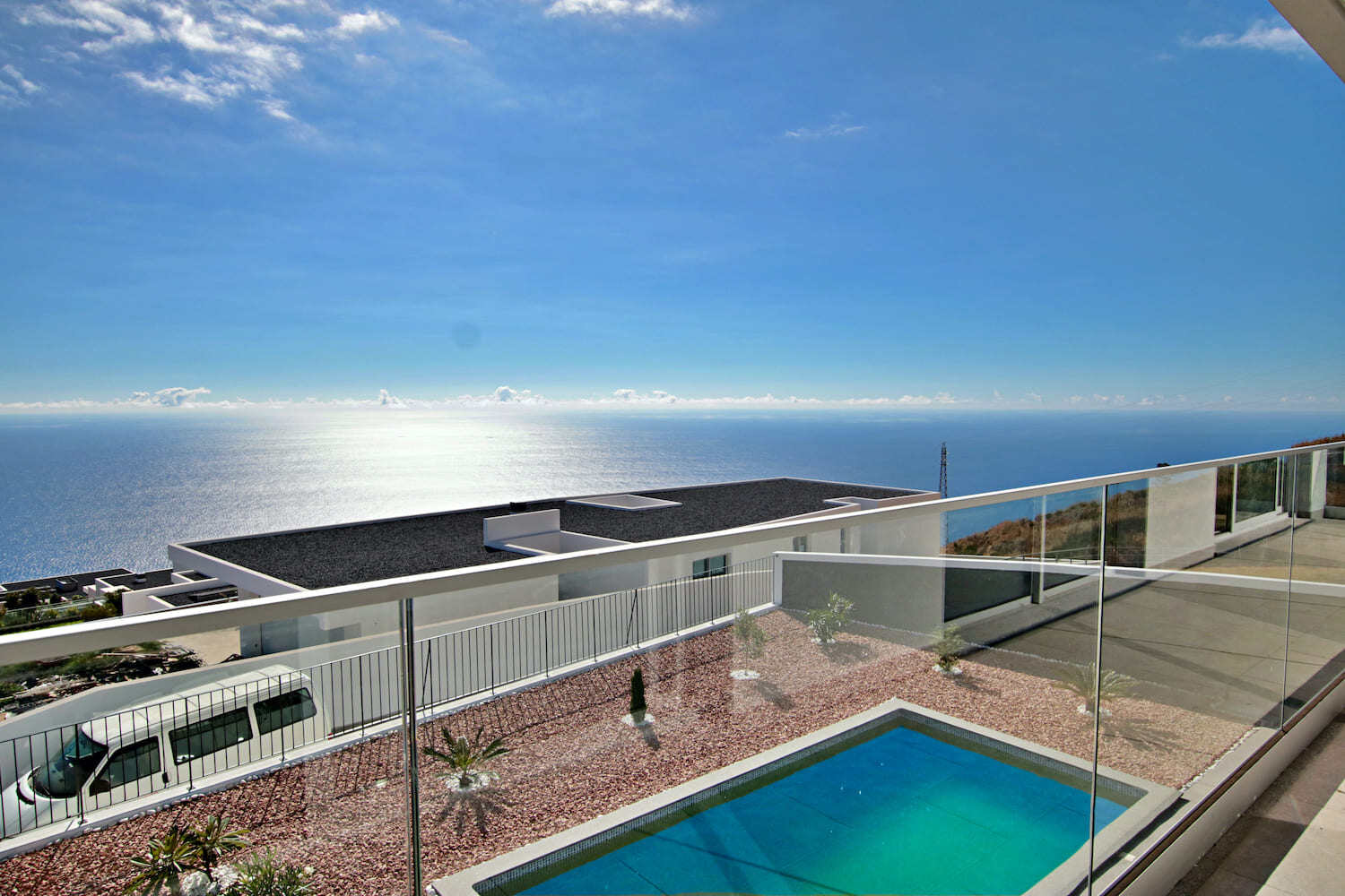 Pool, garden and sea view seen from the veranda 